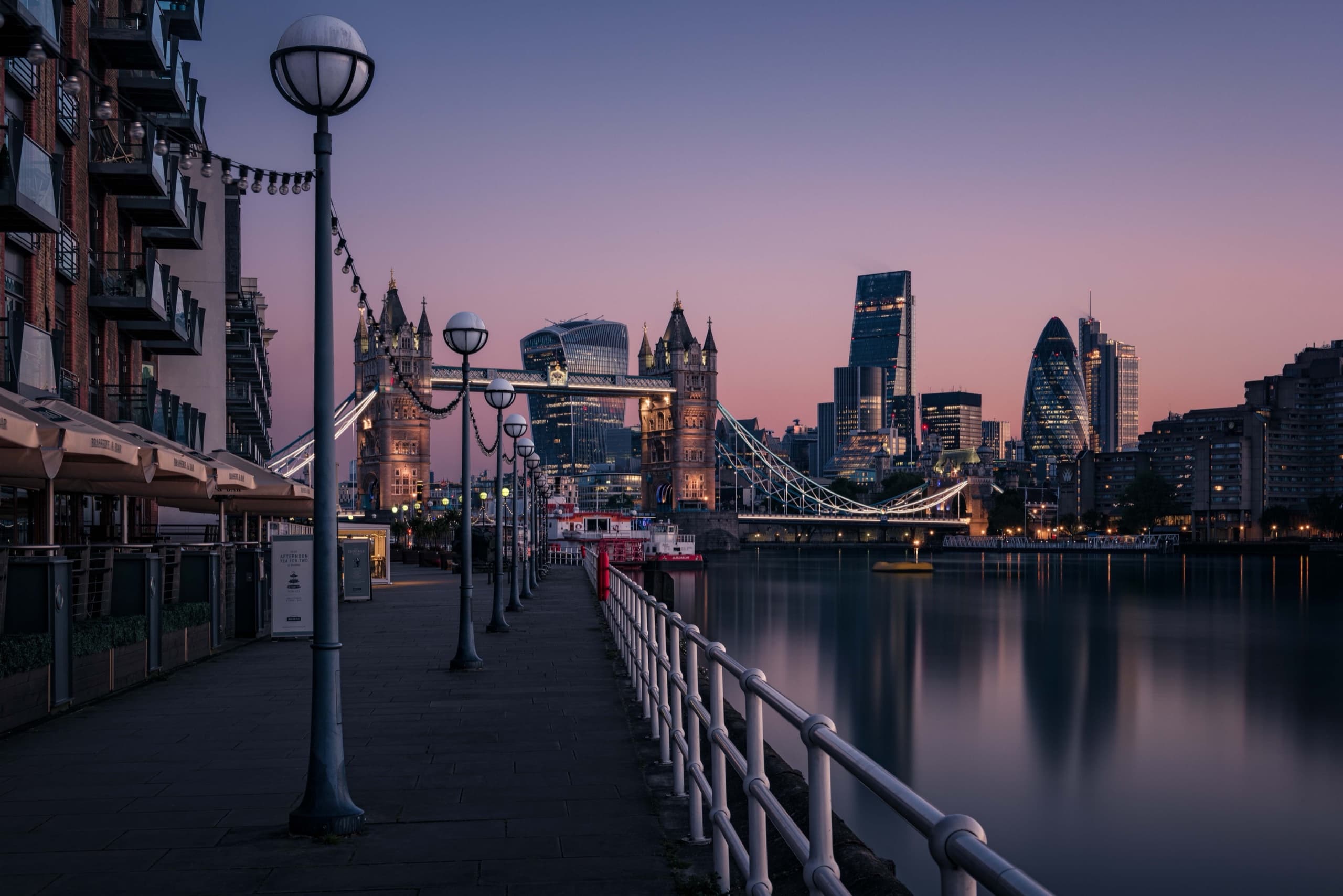 Tower Bridge and the City of London from the Thames riverside at dusk